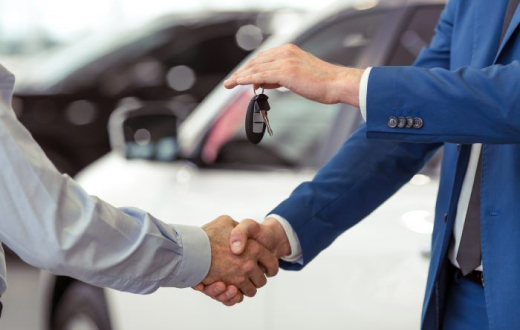 Car sale handshake with keys